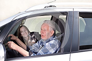 Granfather, grandchild and dog in car