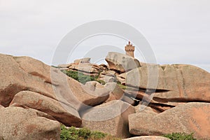 Granite boulder and lighthouse in Brittany