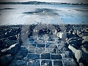 A granite causeway that appears at low tide.