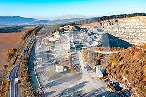 Granite quarry against a background of blue sky, large piles of stone and huge deposits of granite in the rocks