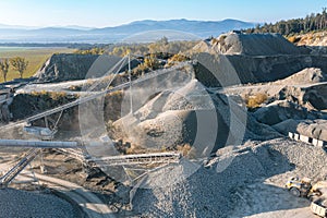 Granite quarry against a background of blue sky, large piles of stone and huge deposits of granite in the rocks