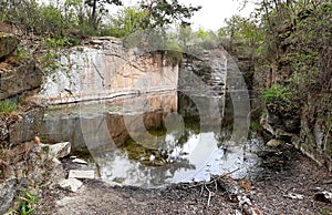 Granite quarry is very old completely flooded vertical walls heading to the water quarry is clean for swimming mining