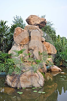Granite rockery in pond water photo