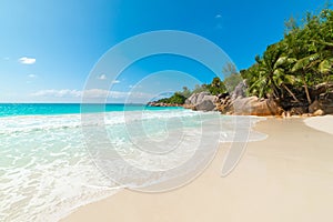 Granite rocks, palm trees and turquoise water in Anse Lazio