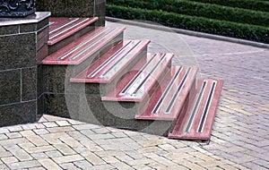 Granite staircase with marble steps and non-slip rubber strips.