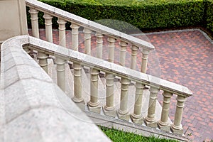 Granite stairs with railings and stone balustrades.