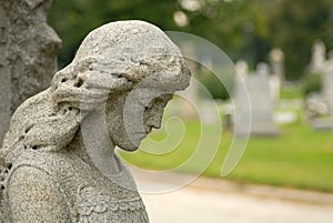 Granite statue of angelic woman at a gravesite