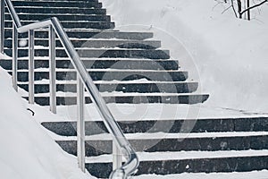 Granite steps in winter covered with snow
