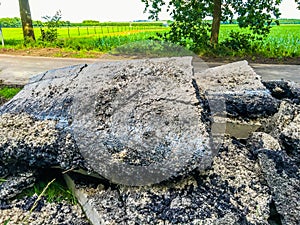Granite stone rock slabs of a demolished road in a nature landscape