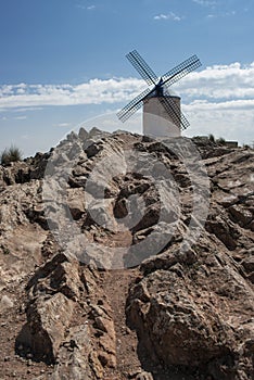 Granite on top of a hill in Castilla La Mancha with a windmill photo