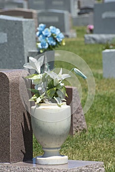 Granite vase of artificial fabric lily flowers