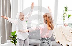 Granmother and granddaughter exercising photo