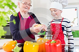 Granny cooking together with her grandson