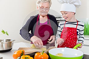 Granny cooking together with her grandson