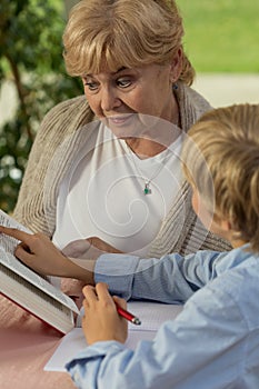 Granny and grandchild reading book