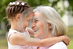 Granny and granddaughter posing outdoors