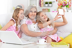 Granny with granddaughters making selfie
