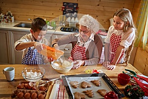 Granny making Christmas cookies with kids