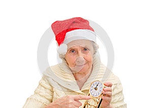 Granny in red Santa Claus hat and clock