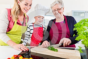 Granny showing old family recipe to grandson and daughter