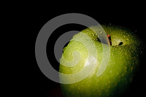 Granny Smith apple on black