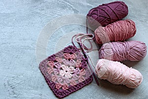 Granny square pattern crocheted of pink cotton yarn. Arts and crafts