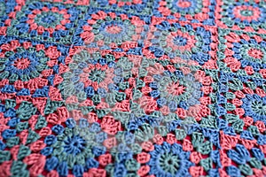 Granny squares crochet afghan in red, blue and green colors