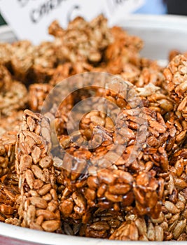 Granola bar in a bowl for sale. Healthy sweet dessert snack. Cereal granola bar with nuts