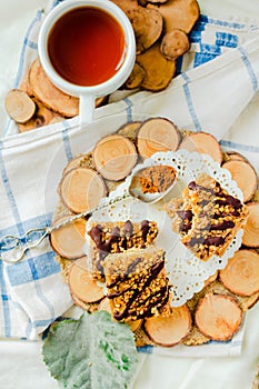 Granola bar cake with date caramel and chocolate. Healthy sweet dessert snack. Cereal granola bar with nuts, fruit and berries on