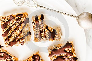 Granola bar cake with date caramel and chocolate. Healthy sweet dessert snack. Cereal granola bar with nuts, fruit and berries on