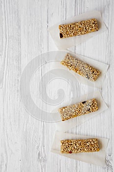 Granola bars on baking sheet over white wooden background, top view. Flat lay, overhead, from above.