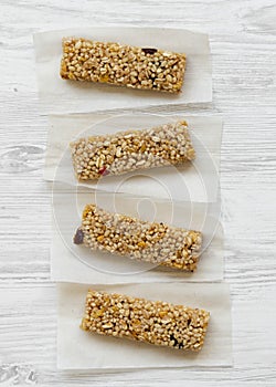 Granola bars on baking sheet over white wooden background, top view. Flat lay, overhead, from above