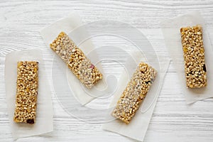 Granola bars on baking sheet over white wooden surface