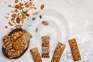 Granola bars and ingredients. Healthy sweet dessert snack. Cereal granola bar with nuts, chocolate and berries on a white