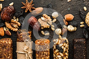 Granola bars with nuts on wooden table