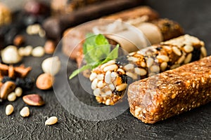 Granola bars with nuts on wooden table