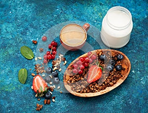 Granola with berries and nuts, yogurt and cup espresso coffee