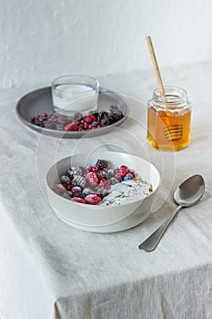 Granola with berries, yoghurt and honey. Raspberries, blueberries, currants