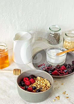 Granola with berries, yoghurt and honey. Raspberries, blueberries, currants