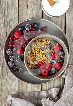 Granola with berries, yoghurt and honey. Raspberries, blueberries, currants