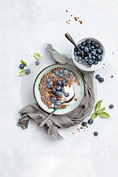 Granola and blueberry breakfast with plain yogurt, top down view