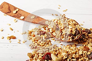 Granola bowl with raisins, nuts and fresh berries. Homemade crunchy granola on grey concrete background, top view