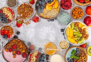 Granola bowl with yogurt and fresh almonds, blueberries, raspberries,peach, kiwi, strawberries and banana