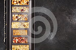 Granola cereal bars on a black background with copy space