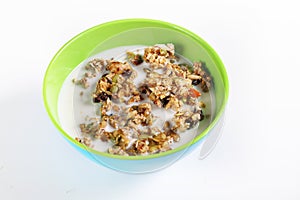 Granola cereal with milk on white