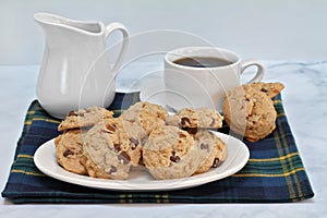 Granola chocolate chip cookies on a plate with coffee.  Macro with copy space