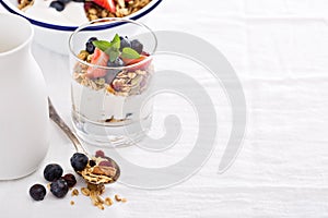 Granola with fresh berries in a blue bowl
