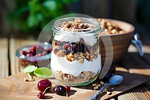 Granola in a glass with yogurt with berries and nuts