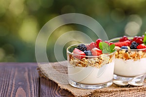 granola with greek yogurt and berries in two glasses