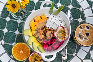 Granola with greek yogurt, honey, fresh fruits, chia seeds served with ice americano